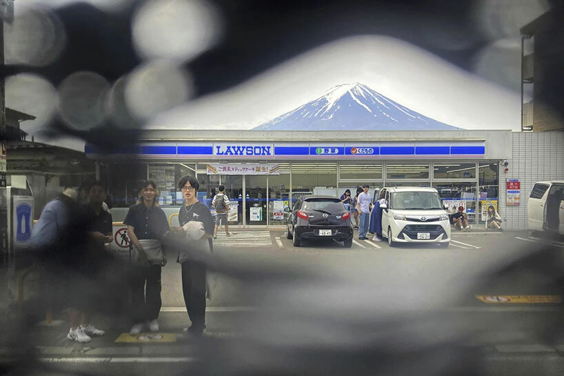 japan installs fence to protect mt. fuji, tourists poke holes to snap perfect photo