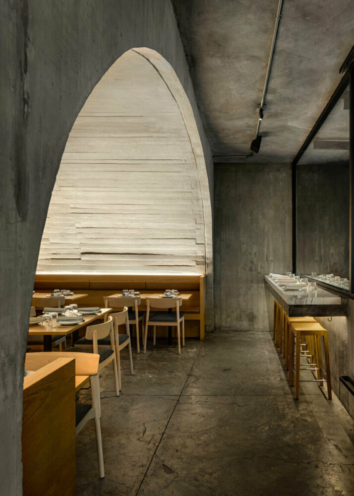 the curved design of the vault is utilized to create a wine cellar