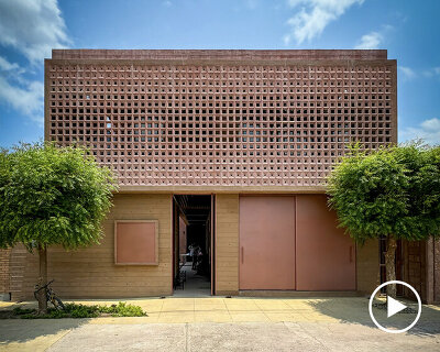 concrete lattice facade floods oaxacan community hub with patterned shadows