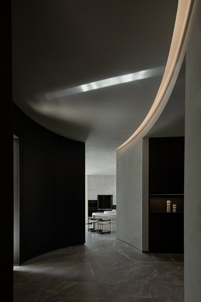 Lycent Design Studio uses contrasting color tones between the bedroom and the office area