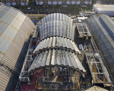 a pleated glass canopy by heatherwick studio rises amid london's olympia site