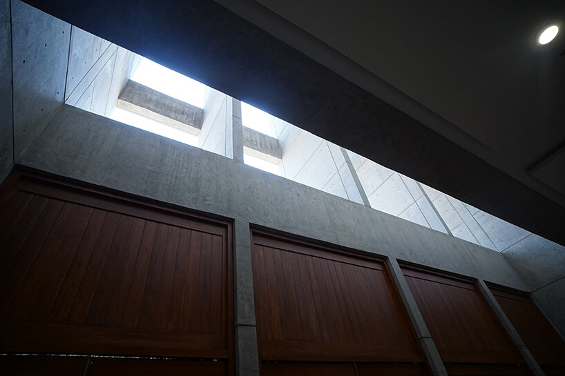 large windows and architectural fins on the facade ensure natural light and functional aesthetics