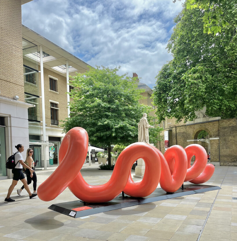 yoni alter's climbable, looping sculpture in london unravels to reveal the word 'love'