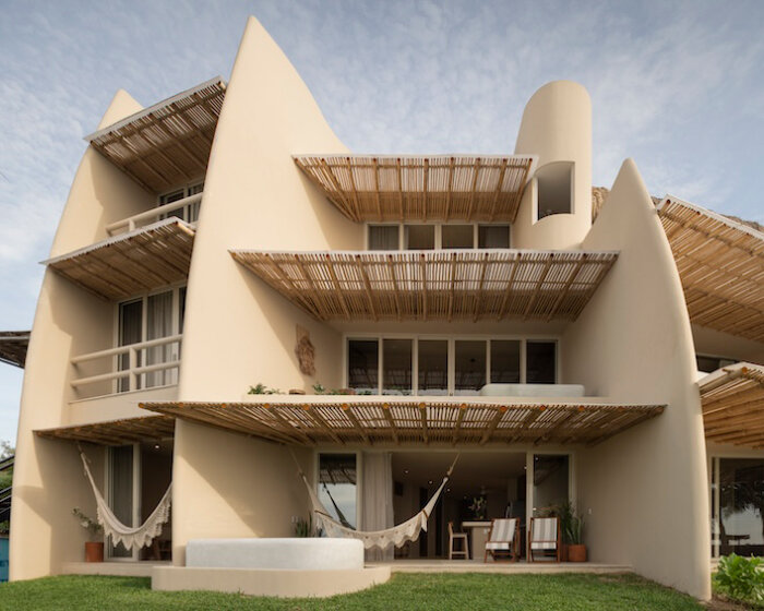 sustainable coastal housing in mexico welcomes surfers to its fluid form