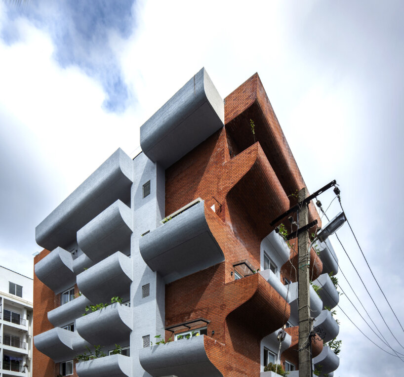 curving balconies double as environmental filters at purple ink studio's housing complex in bangalore