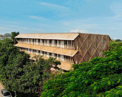 BLOOM screens girl dormitory's concrete skeleton with woven bamboo skin in cambodia