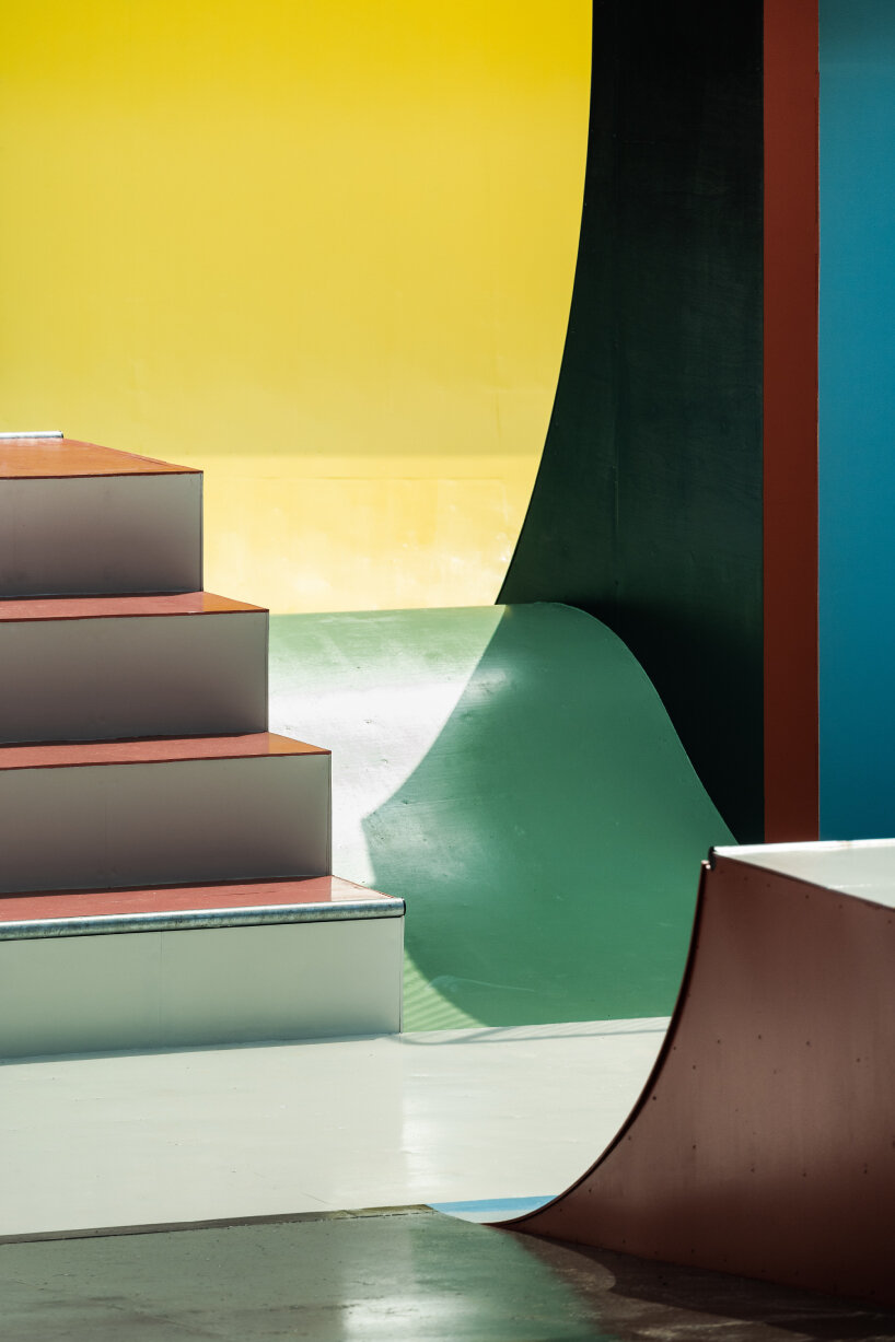 the skateable sculpture has the ochre colors of red, green, and yellow