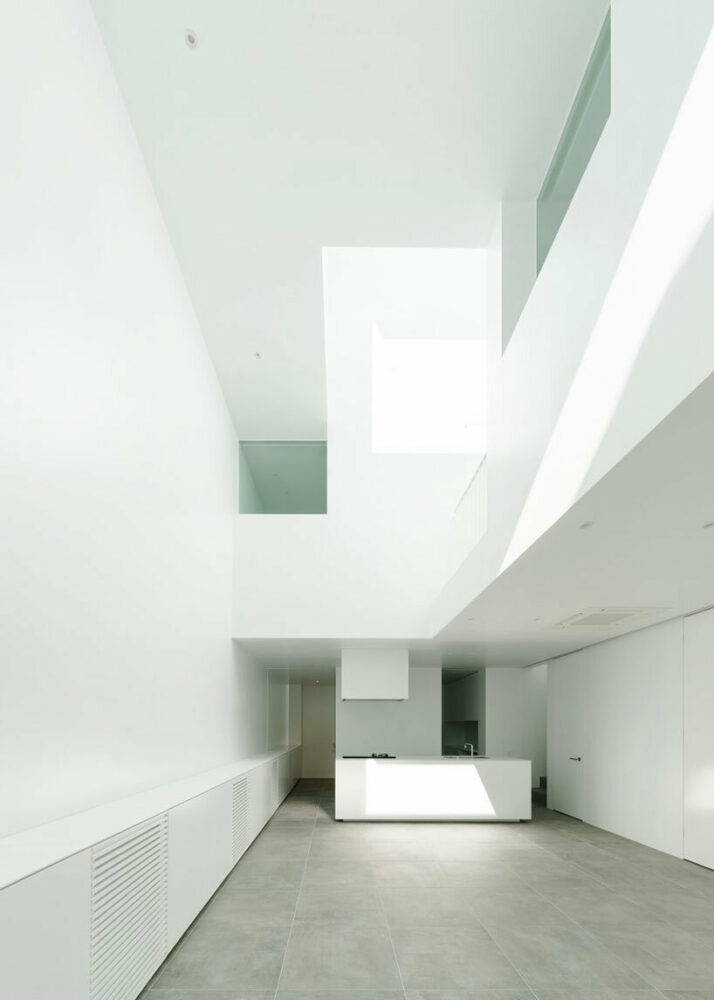 two-story and three-story atriums at different angles illuminate the residence