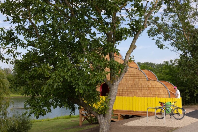 wrapped in wooden shingles, kollektiv plus x's cloud-shaped cyclist shelter ascends to views over iron curtain