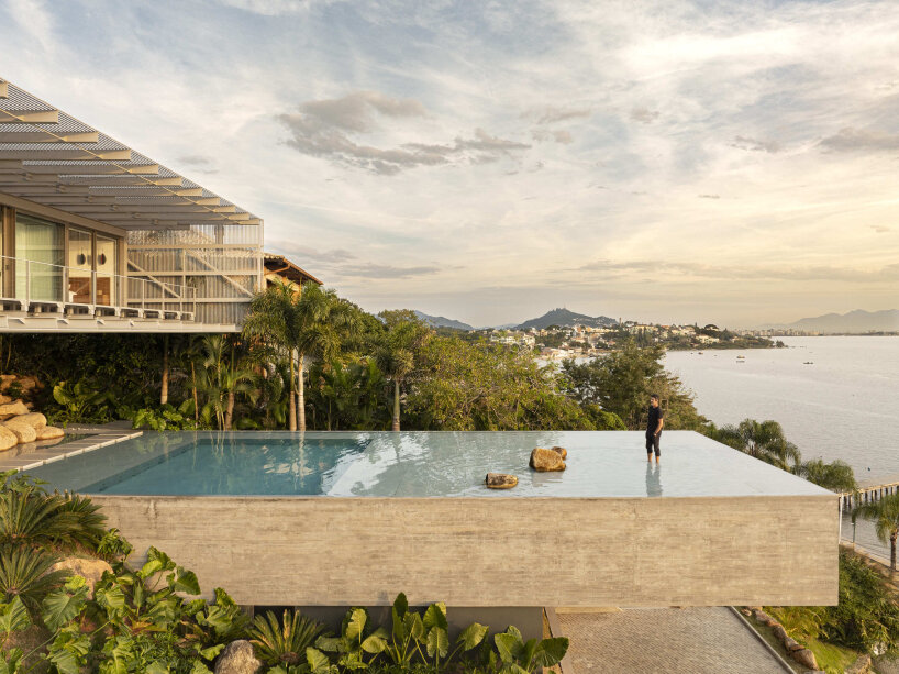 with a suspended infinity pool, tetro architecture's ponte house hangs from the hillside in brazil