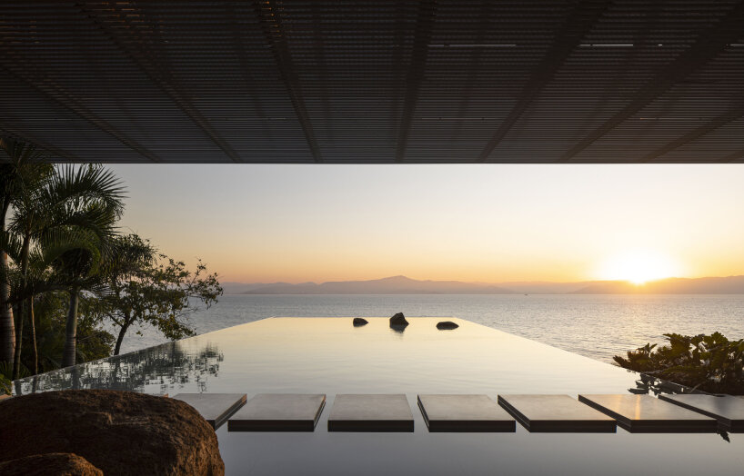 with a suspended infinity pool, tetro architecture's ponte house hangs from the hillside in brazil