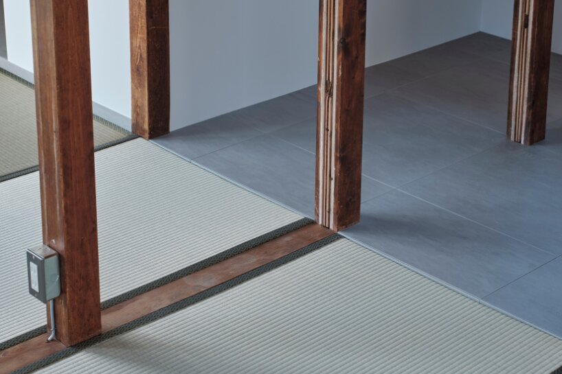 the interior of the two-story house features exposed wooden framework