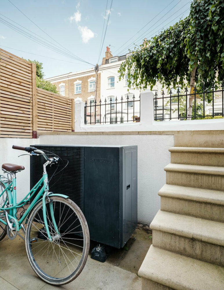 the pump is discreetly positioned below street level at the front of the house