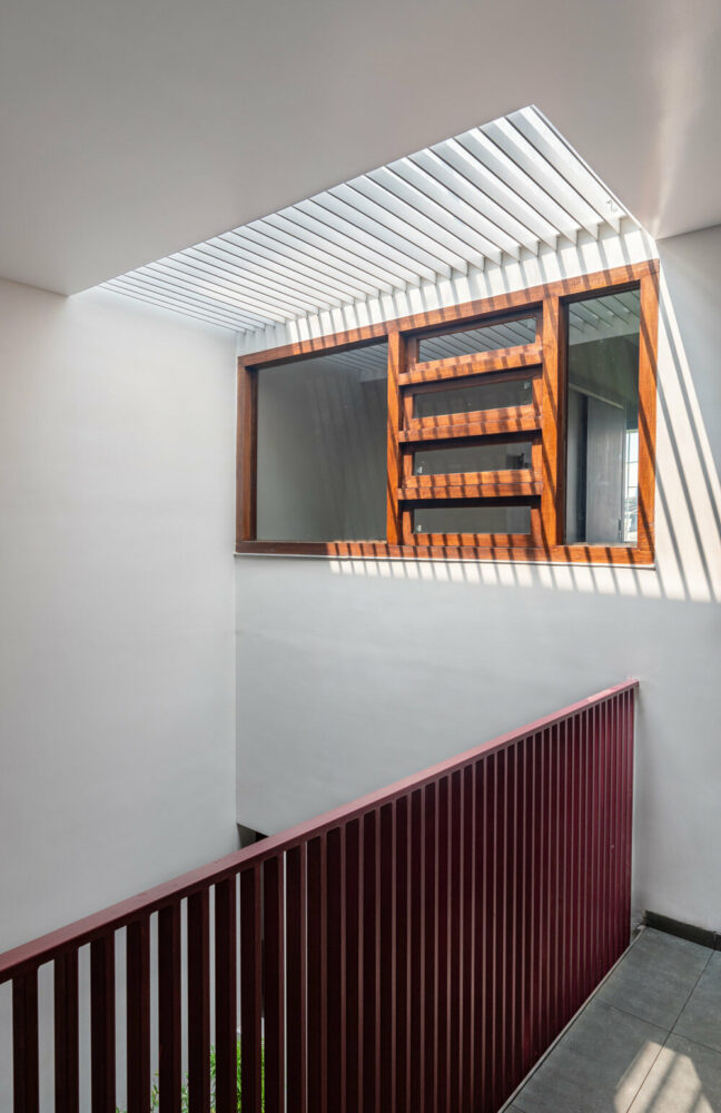 a double-height courtyard welcomes visitors with natural light filtering through a metal grill