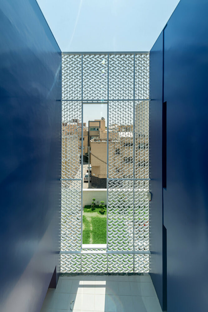 the facade frames a courtyard view at the Paakat Residence