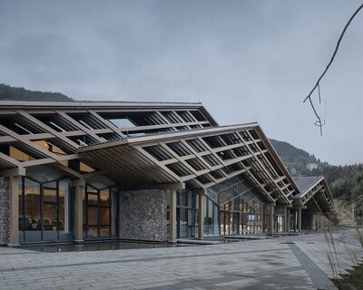 cascading folding roof of GLA design's community center in china echoes mountain contours