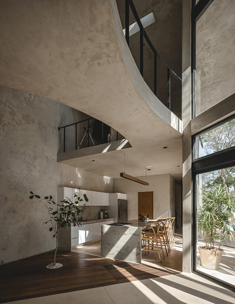 the home’s neutral palette of exposed concrete and polished cement reflects the serenity