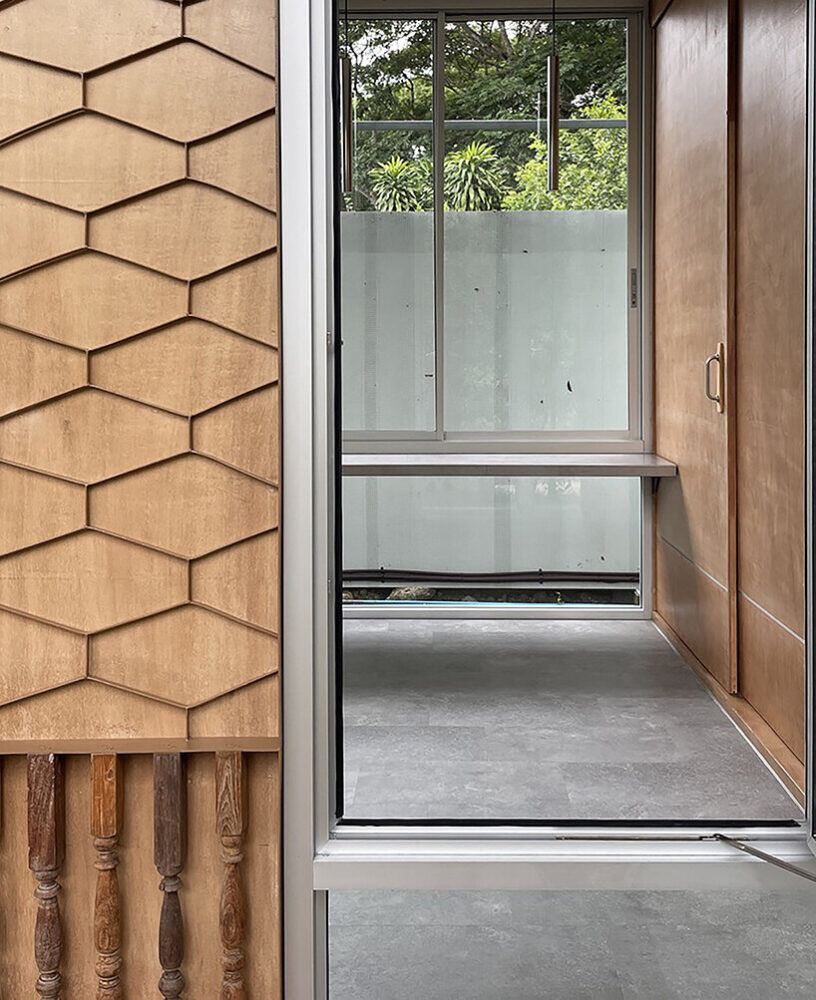 the reuse of old doors and windows reflects the design’s commitment to sustainability