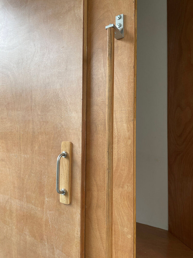 the plywood wall is supported by reused security bars