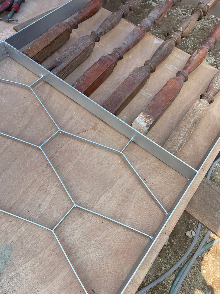 stair balusters from a dismantled house are transformed into structural reinforcements