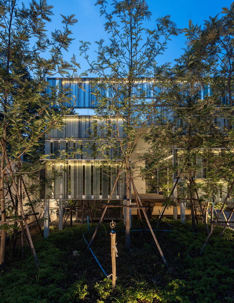 the recycled glass glistens as it catches the sunlight, softening the edges of the house