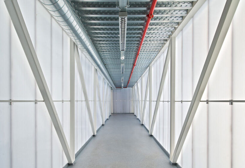 color-coded interior elements, such as railings and signage, reinforce the brand’s identity