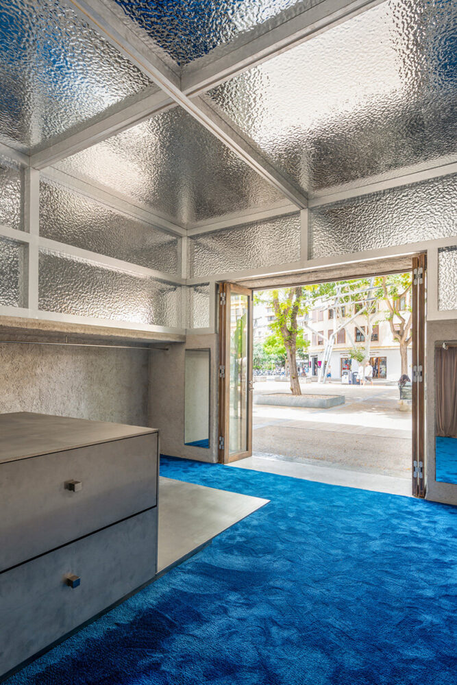 the racks and ceiling work together to bring coherence and balance to the design