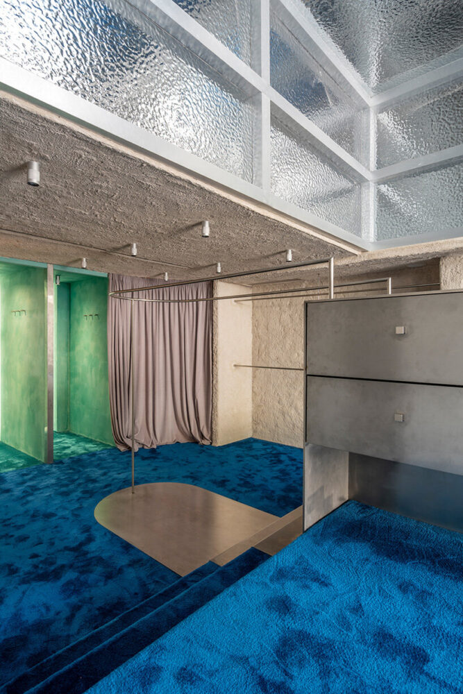 a curved curtain that conceals the three fitting rooms