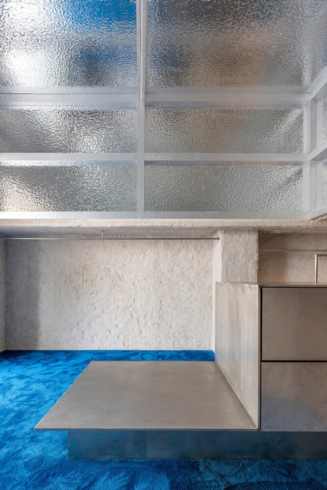 a mezzanine is accessible by a spiral staircase at the back