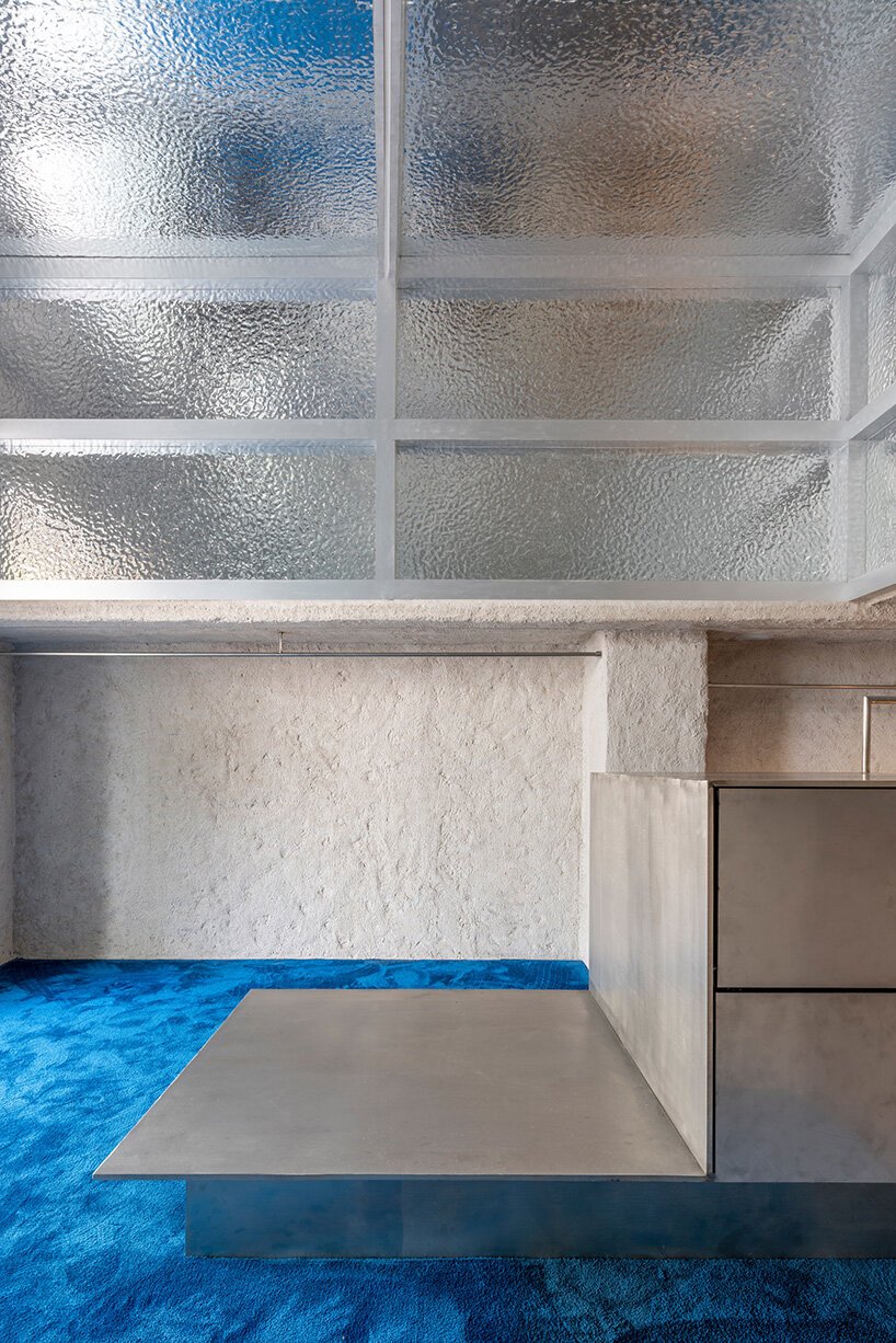 a mezzanine is accessible by a spiral staircase at the back