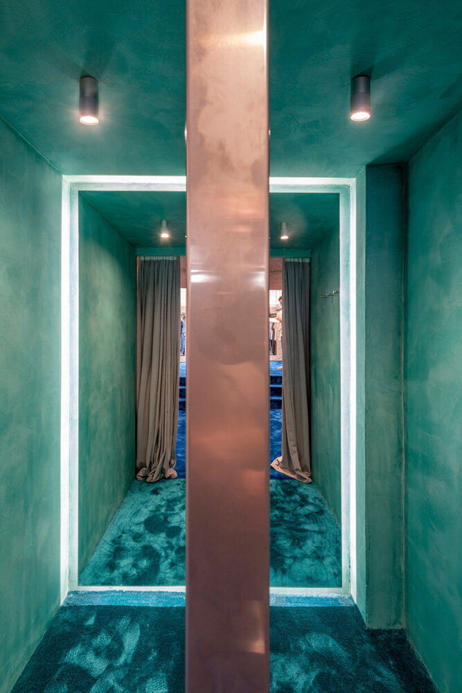 finished in turquoise stucco with matching carpets, the fitting rooms resemble caves in the sea