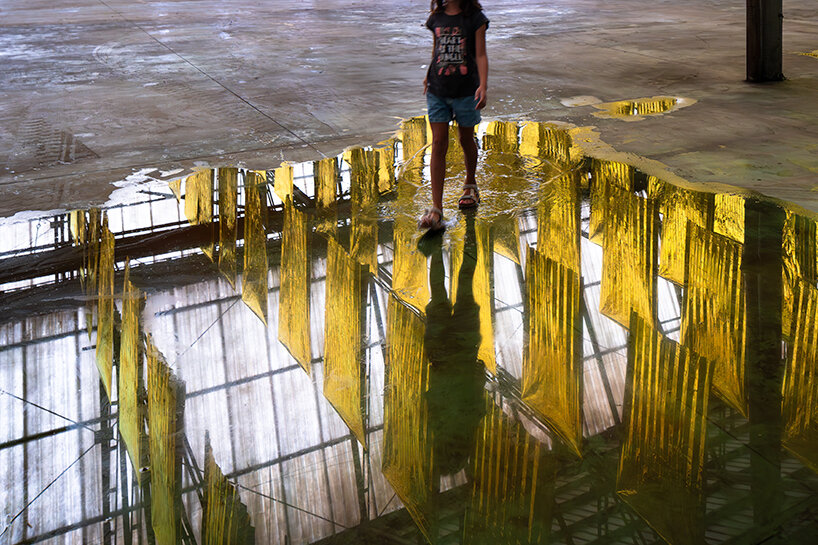 bathing the space and its visitors in shifting reflections and acoustic whispers