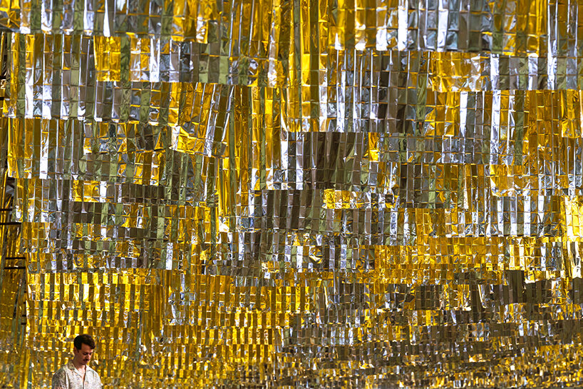 visitors navigate the installation, experiencing the reflective surfaces and evolving soundscapes