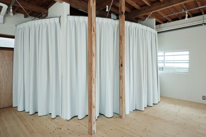 wet areas are defined using round-shaped PVC tiles and curved curtains for a subtle visual distinction