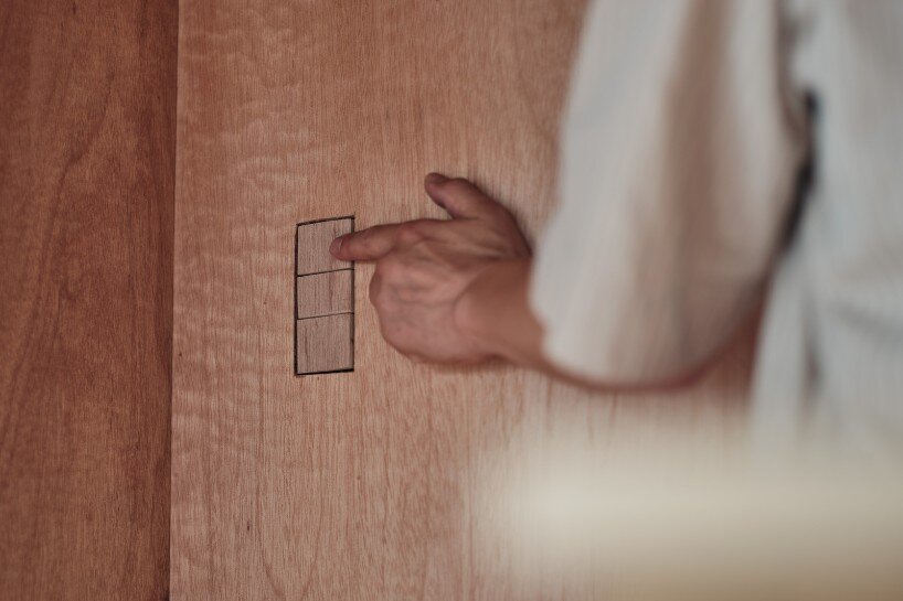 custom-made lighting and switches, crafted from lauan, enhance the cohesive design