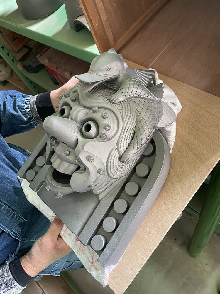 the traditional Oni-Gawara (gargoyle) serves as the inspiration for the new wall lamp
