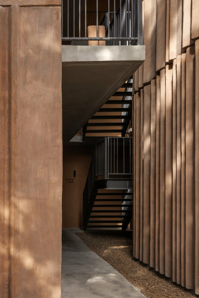a semi-open courtyard houses a central staircase with common access