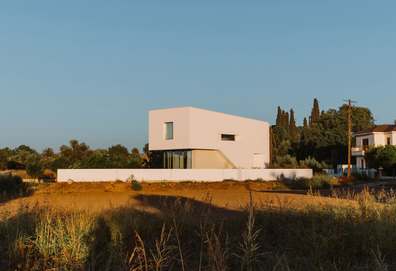 cypress-lined landscape embraces versa architecture's villa JJ in cyprus