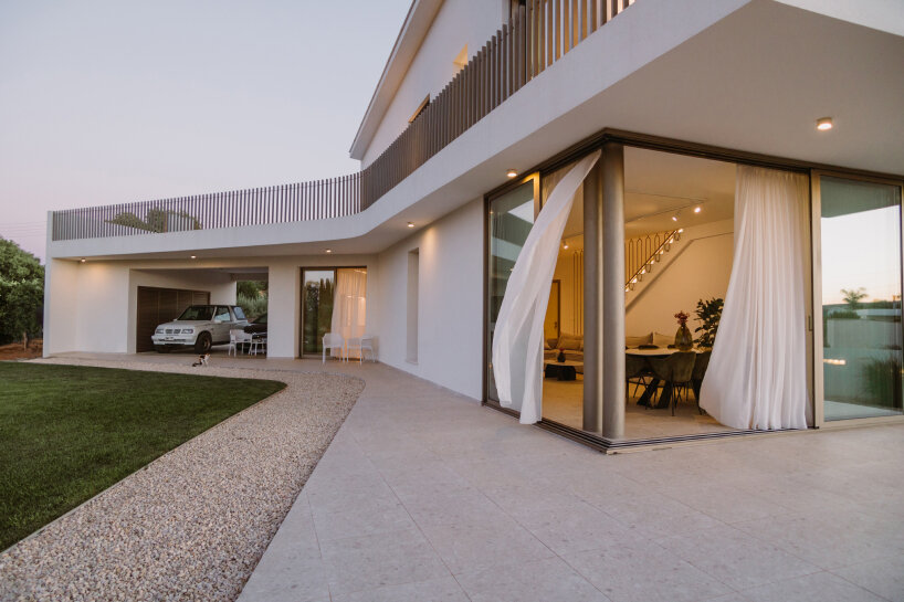 cypress-lined landscape embraces versa architecture's villa JJ in cyprus