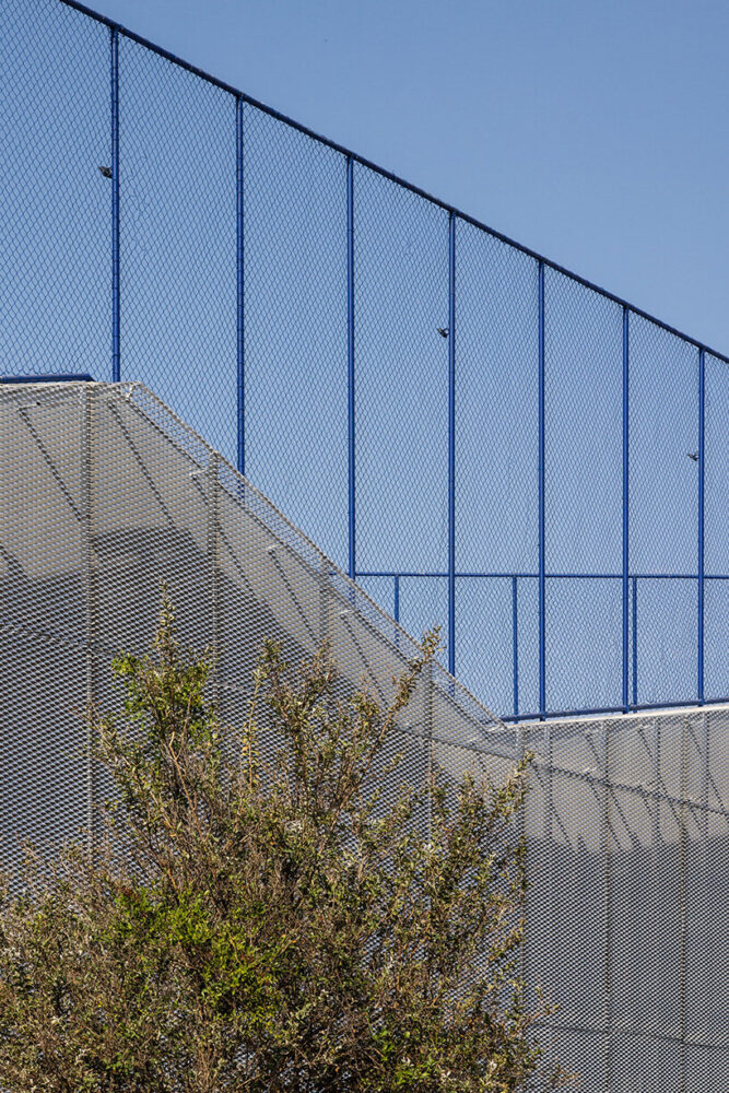 a second skin made of exposed aluminum sheet metal filters sunlight