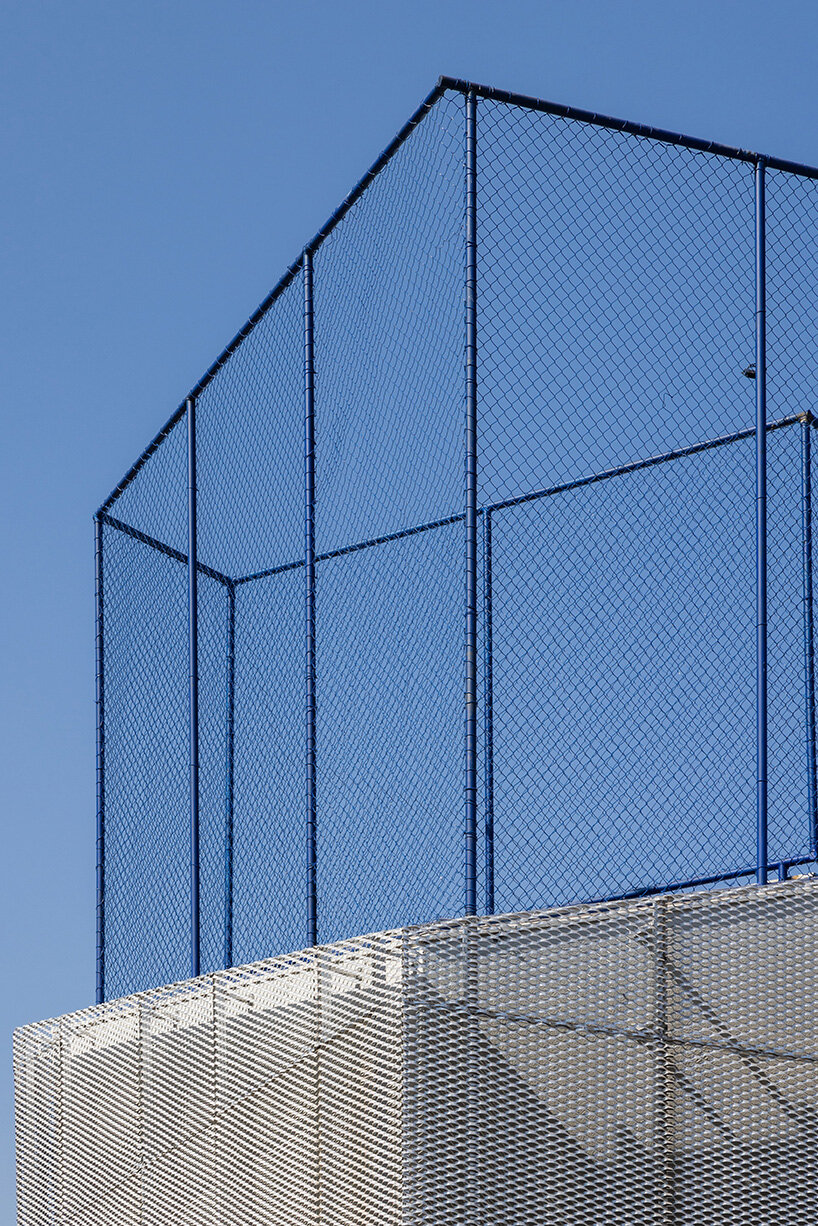 classrooms and sports court are elevated to maximize openness on the ground floor