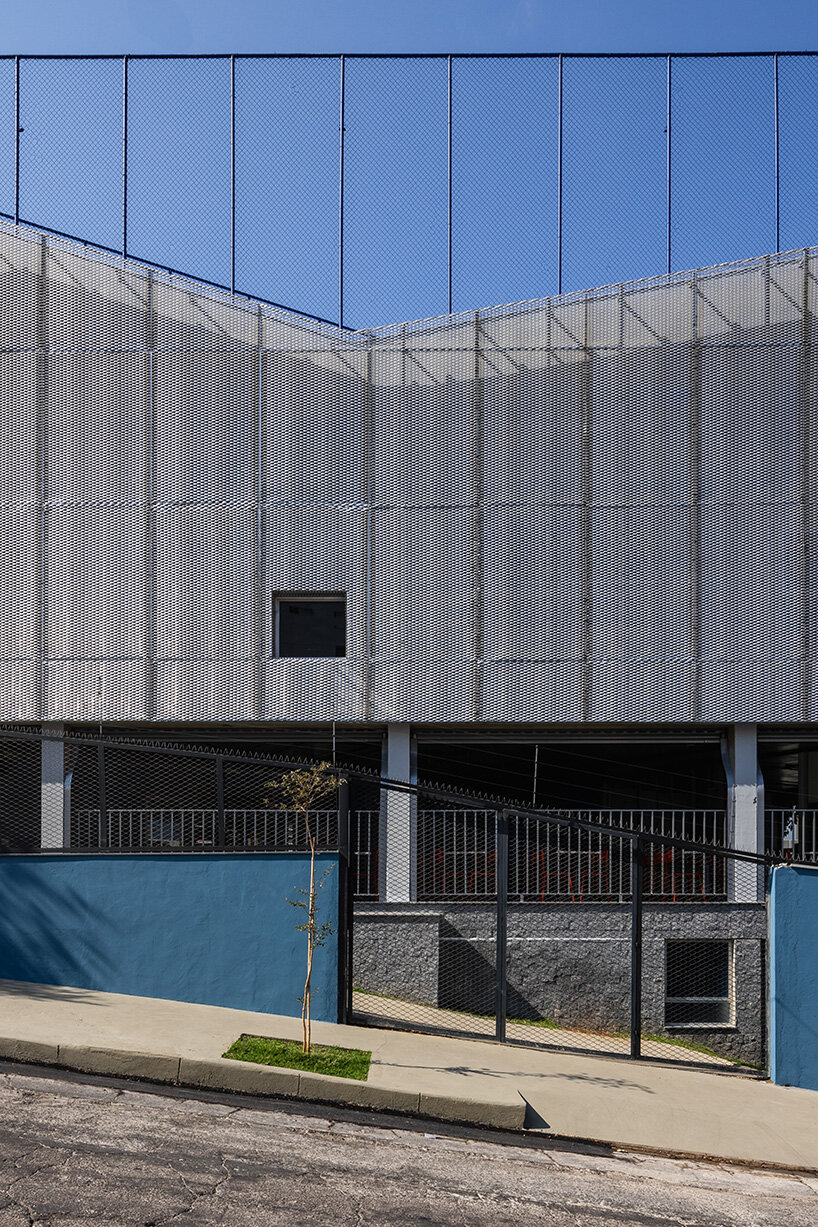 windows of varying sizes cut through the facade 
