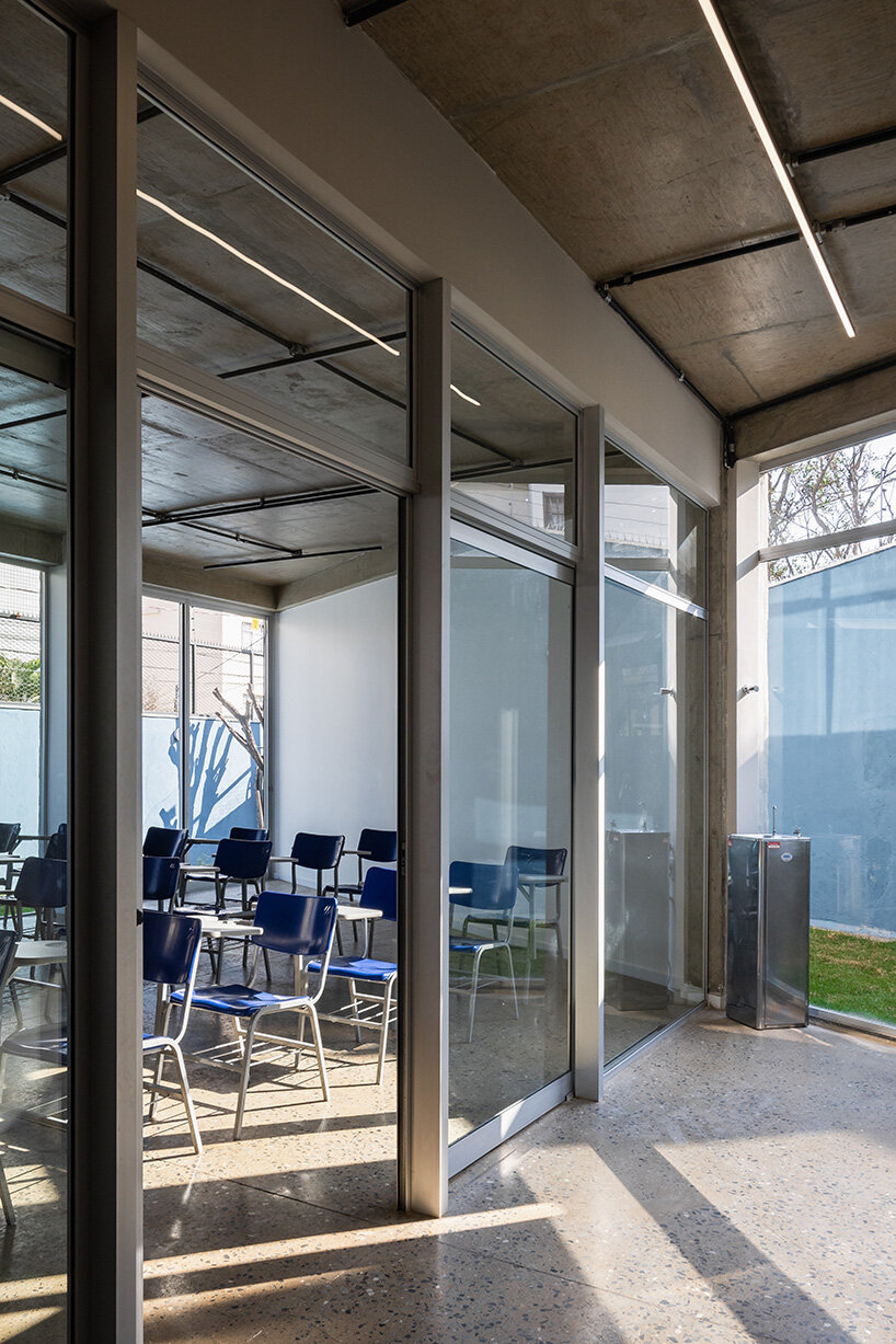 polished concrete floors and exposed slabs add to the raw appearance of the Alumnus School