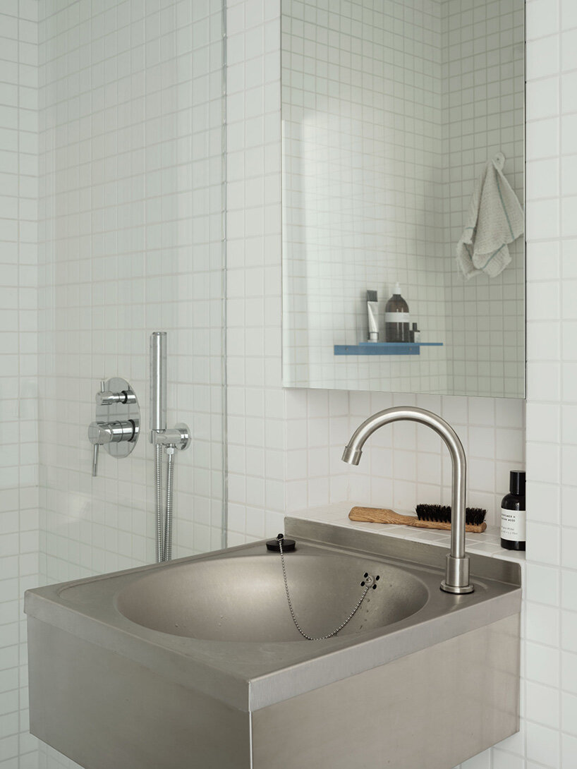 white tiles clad the bathroom walls