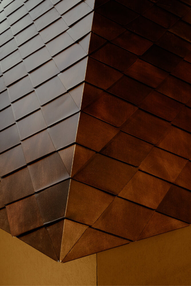 diamond-shaped metal tiles clad the roof