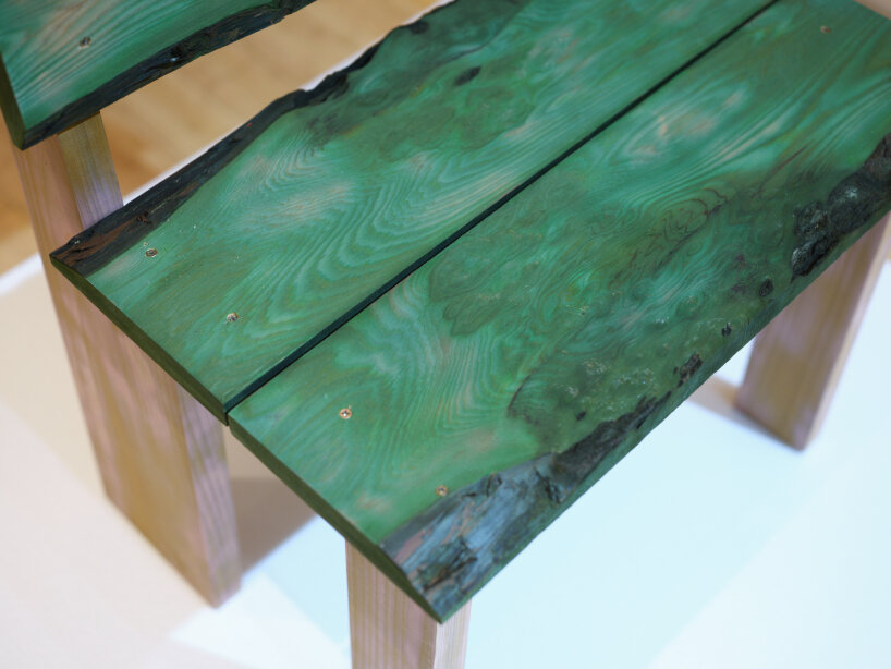 Saki Takeshita varies the time she blows dry the dyed balsa wood with hot air