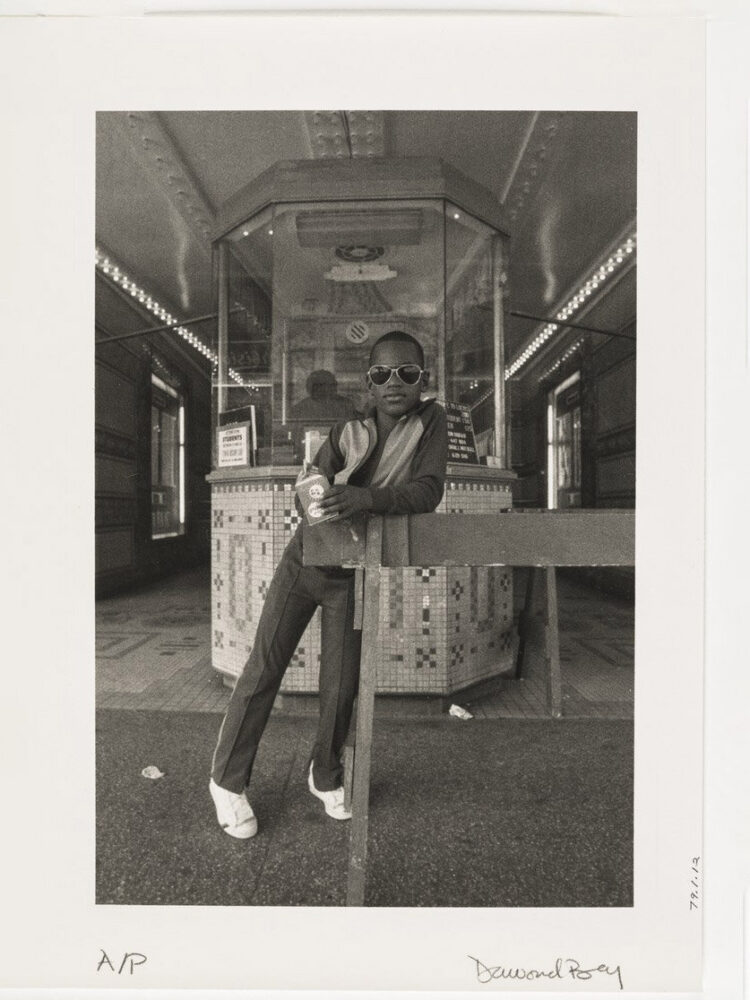 Dawoud Bey, A Boy in Front of the Loews 125th Street Movie Theater (from the series 'Harlem U.S.A.'), 1976. Silver print, 8 1/2 × 5 3/16 in. Studio Museum in Harlem; gift of the artist 1979.1.12; courtesy the artist. photo by Zalika Azim