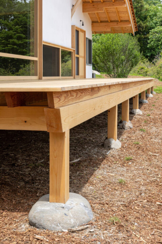 a large deck steps on a stone foundation 