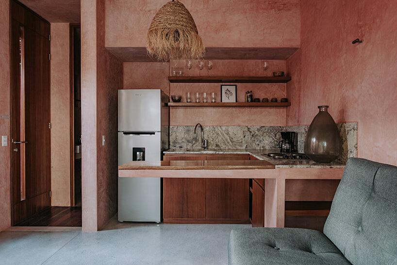 the entrance to the main social area reveals a kitchen, living room, and full bathroom