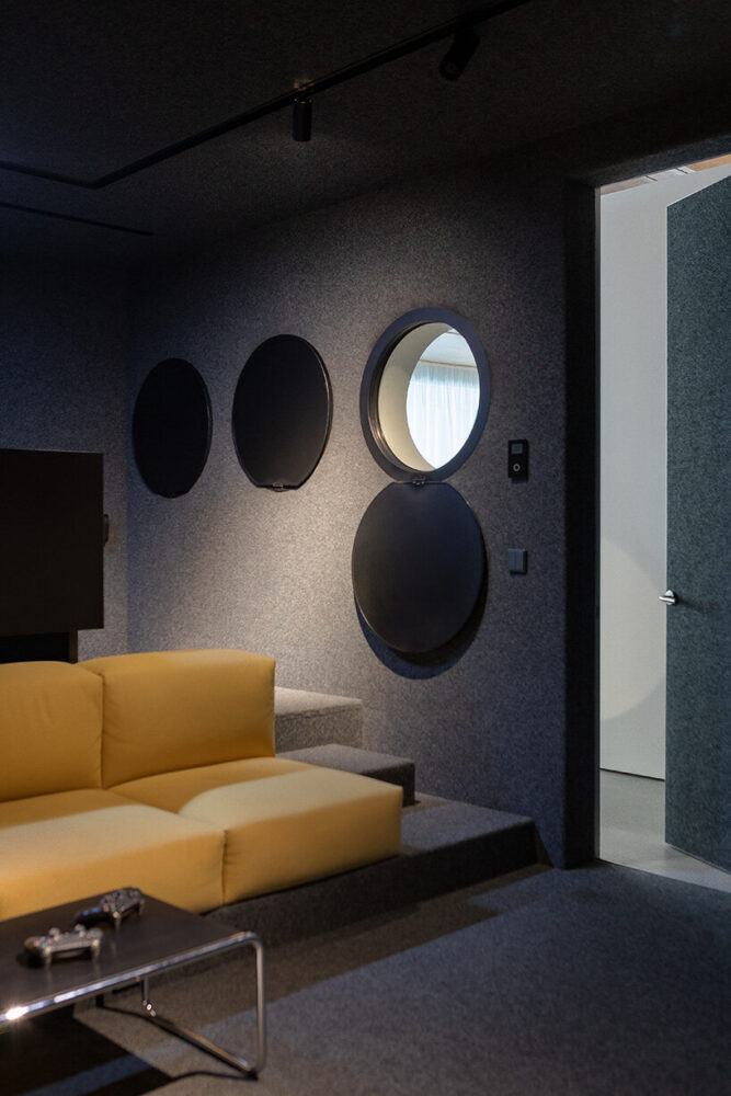 the room’s round windows echo the architecture of the industrial building